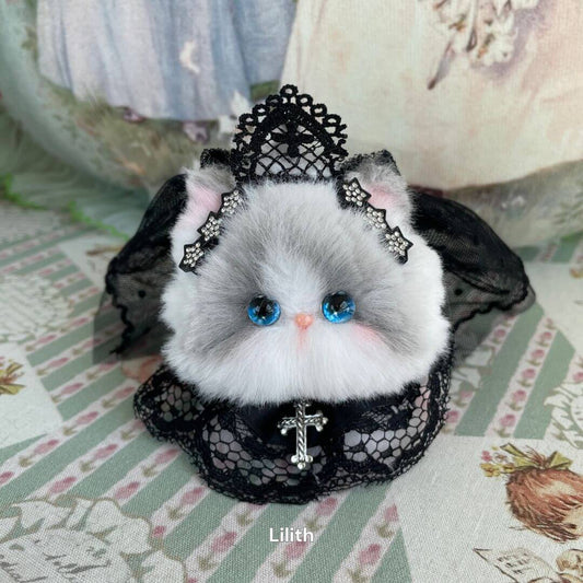 Handmade kitten plush with blue eyes, lace accessories, and faux cross necklace from Fairy Paws Collection.