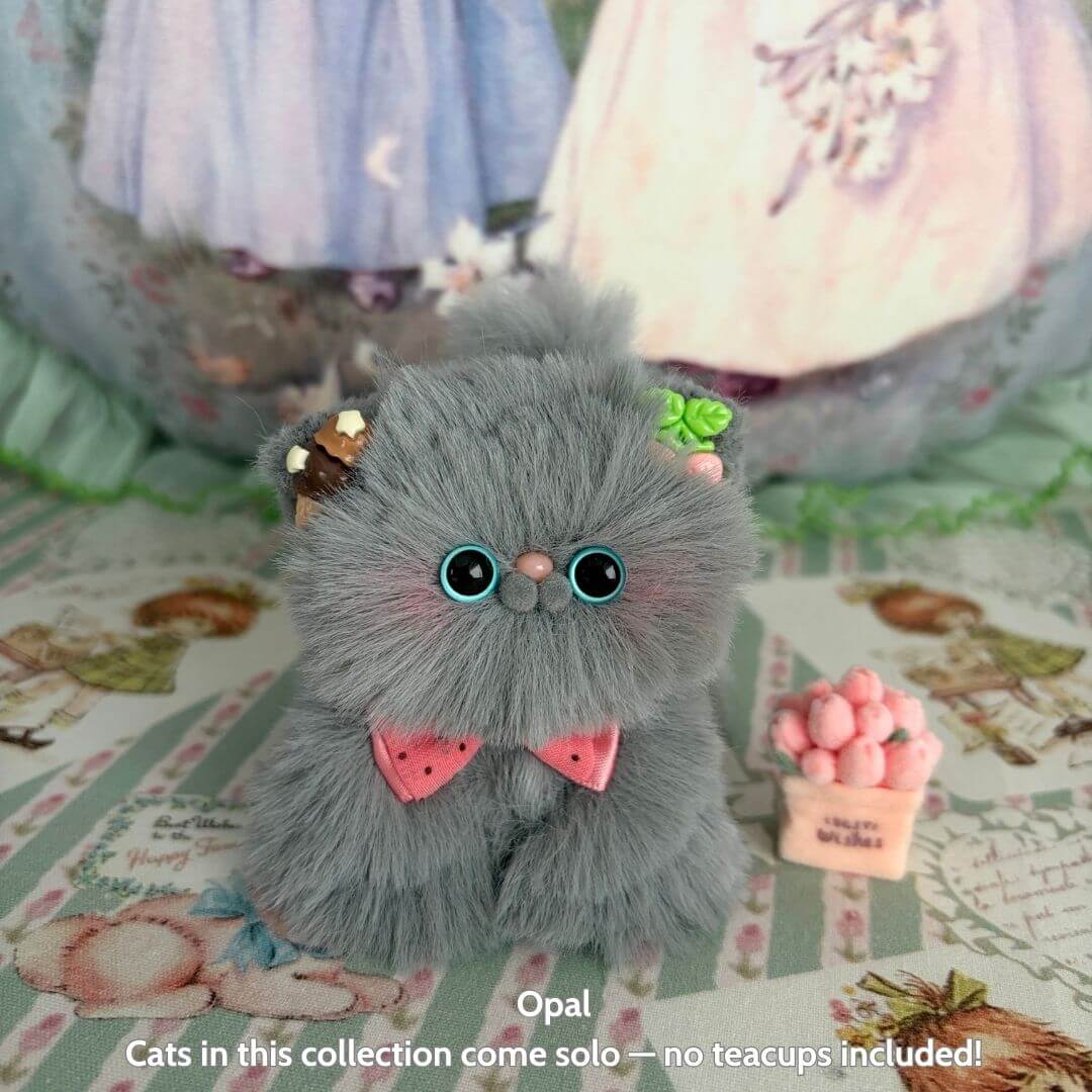 Fluffy Kitten Collection features a cute grey fluffy kitten with a pink bow, decorated with sweets, representing a kawaii cat figurine.