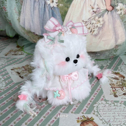 Fluffy kitten figurine from the Enchanted Big Paws Collection, dressed in pastel colors with a pink bow, cute face, and decorative accessories.