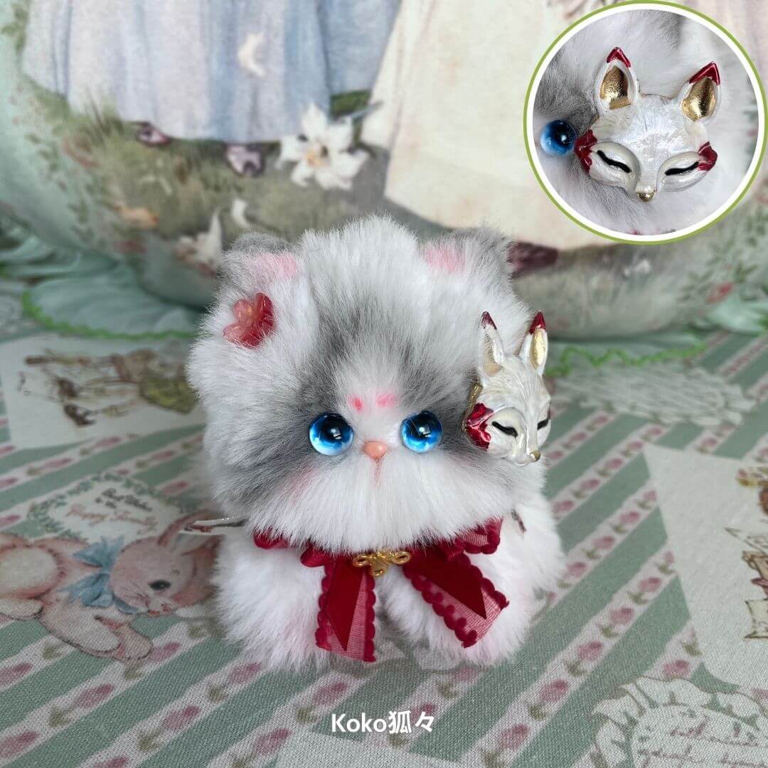 Fluffy gray and white handmade kitten figurine from the Fairy Paws Collection with blue eyes, red ribbon, and fox accessory.