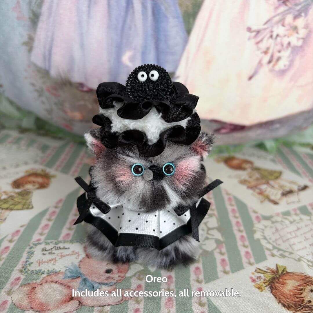 Cute handmade kitten, Oreo, in a ruffled black hat and white outfit; Sweet Treat Kitties collectible animal figurine.