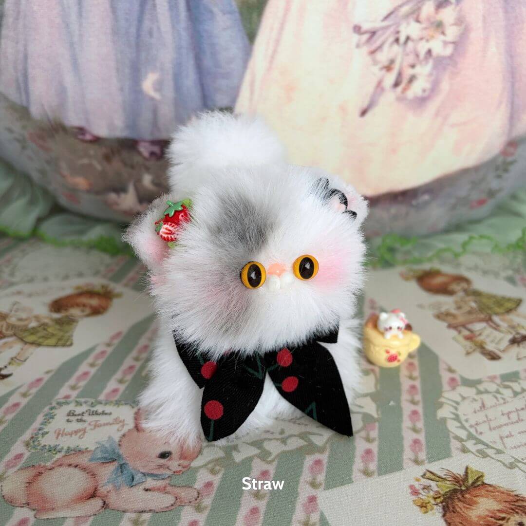 Fluffy Kitten Collection: adorable grey and white fluffy kitten figurine with black bow and strawberry accessory, cute collectible design.