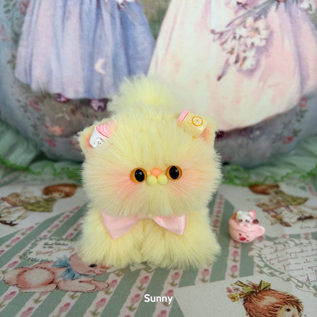 Fluffy Kitten Collection: handmade kitten with pale yellow fur, bow and candy decorations, cute animal collectible in a playful pose.