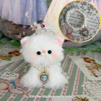 Cute fluffy kitten figurine wearing an Elegant Heart Necklace with pearl accents, perfect for collectible miniature animal decor.