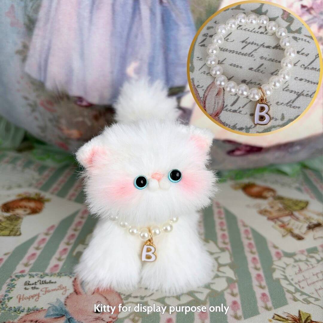 Cute fluffy kitten figurine with a pearl initial necklace, showcasing handmade charm and kawaii style, perfect for collectors.
