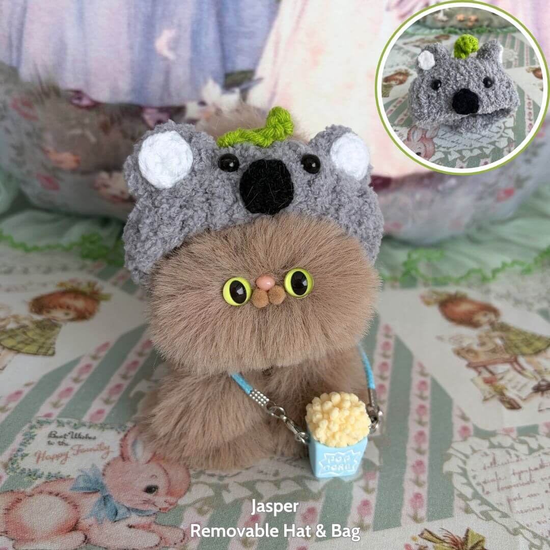 Fluffy Hoodie Kittens figurine with a koala hat, holding a popcorn bucket, handmade kawaii cat in brown tones, cute animal collectible.