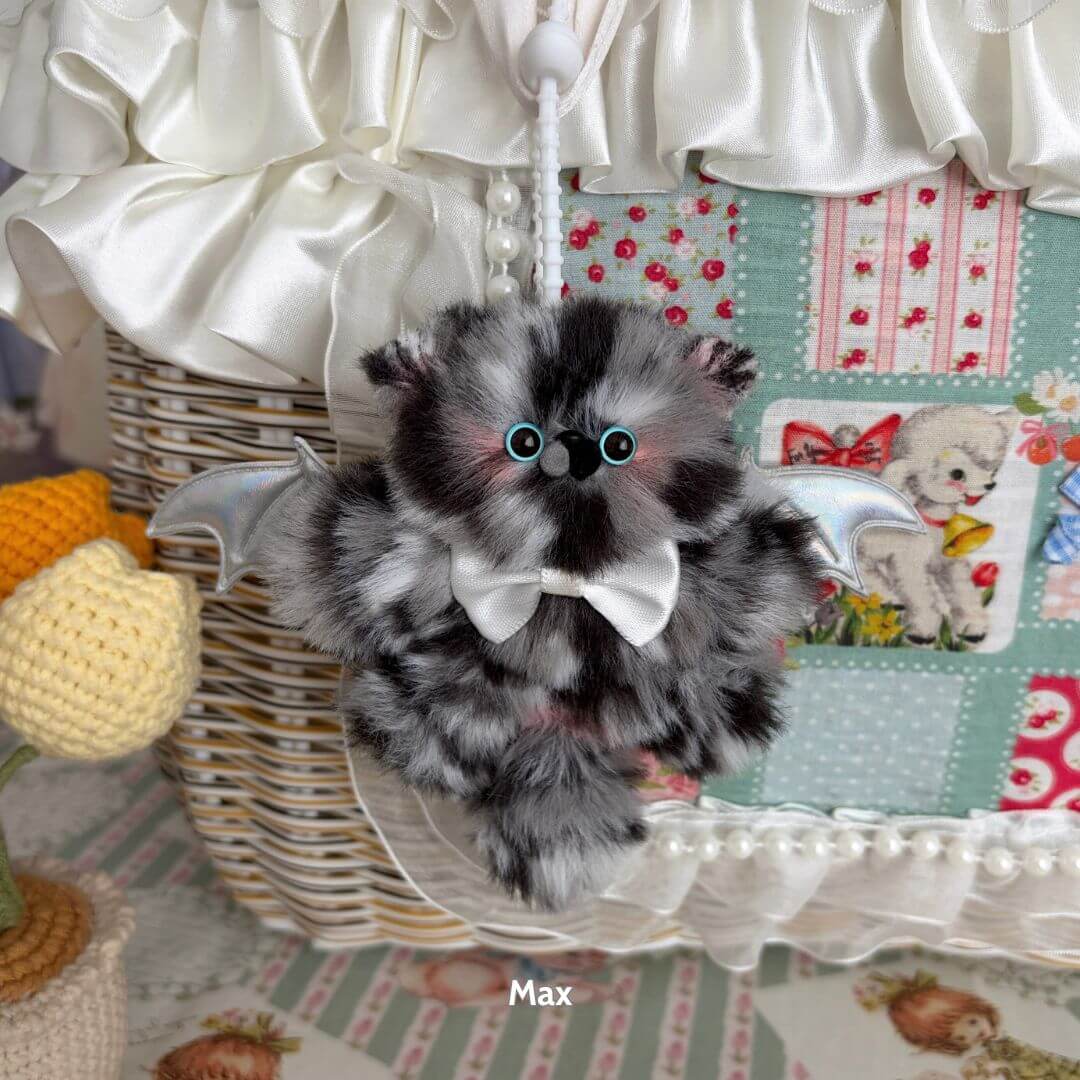 Adorable Winged Kitty Pendants featuring a fluffy black and grey kitten with tiny silver wings and a bow tie, handmade in UK.
