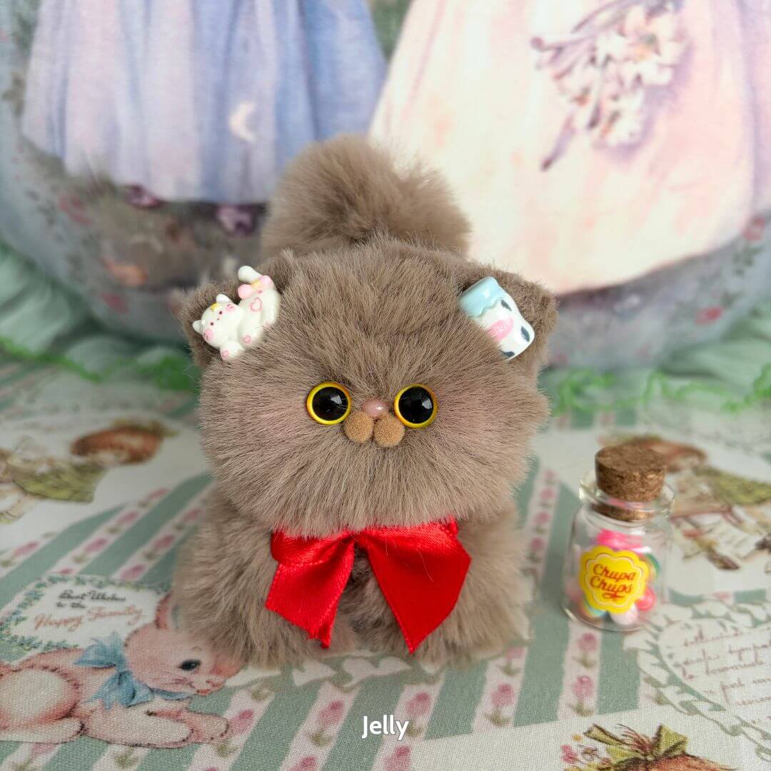 Fluffy Kitten Collection miniature animal decor featuring a kawaii cat figurine with brown faux fur, a red bow, and colorful accessories.