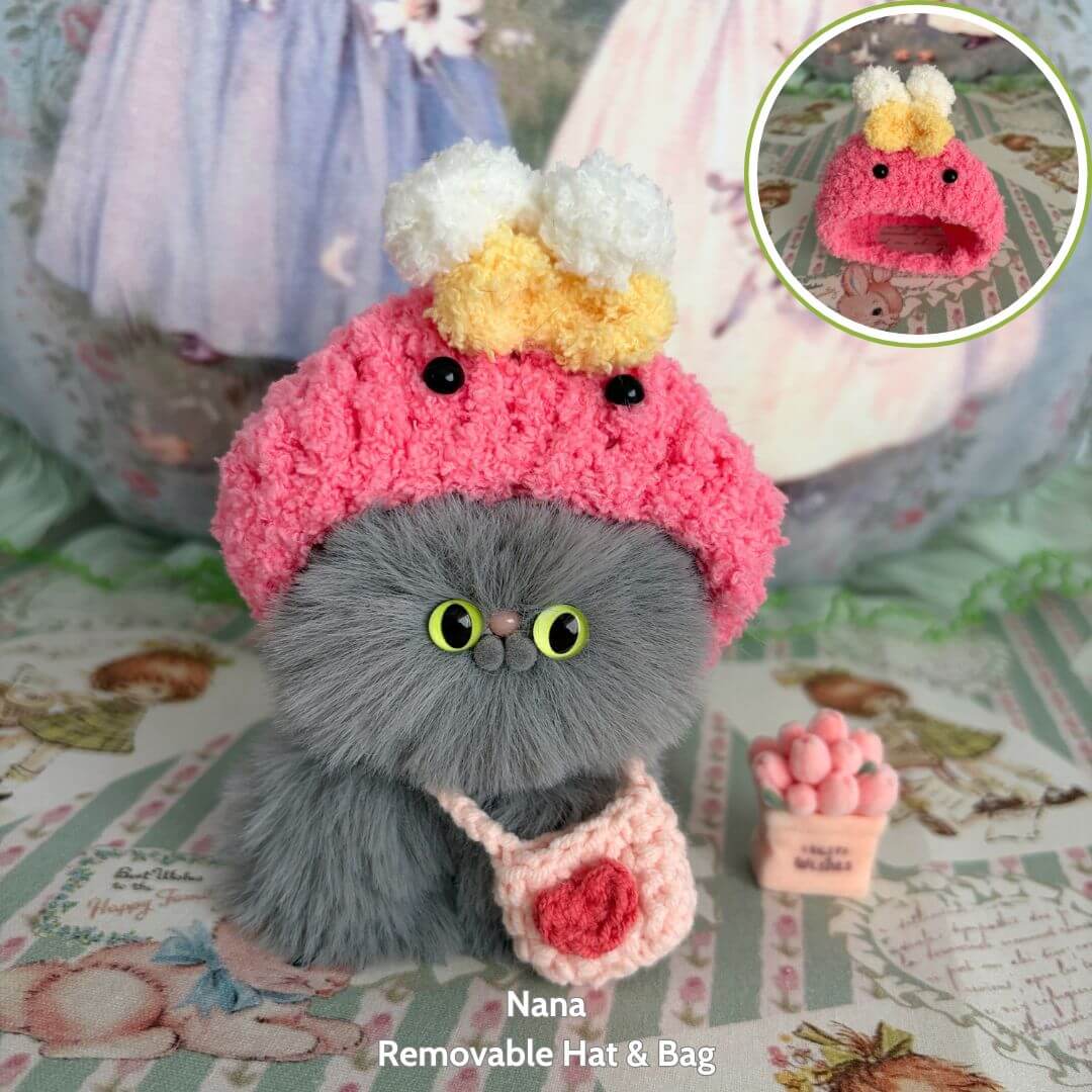 Fluffy Hoodie Kittens: cute grey fluffy kitten figurine wearing a pink crocheted hat and bag, showcasing kawaii style.