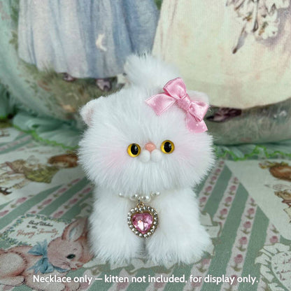 Cute fluffy kitten figurine with a pink bow and elegant heart necklace, designed for display, handmade in UK.