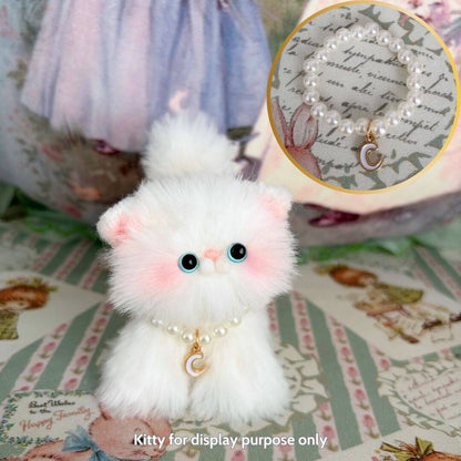 Handmade kitten figurine wearing an Initial Pearl Necklace, featuring fluffy white fur and pink accents, showcased in a whimsical setting.