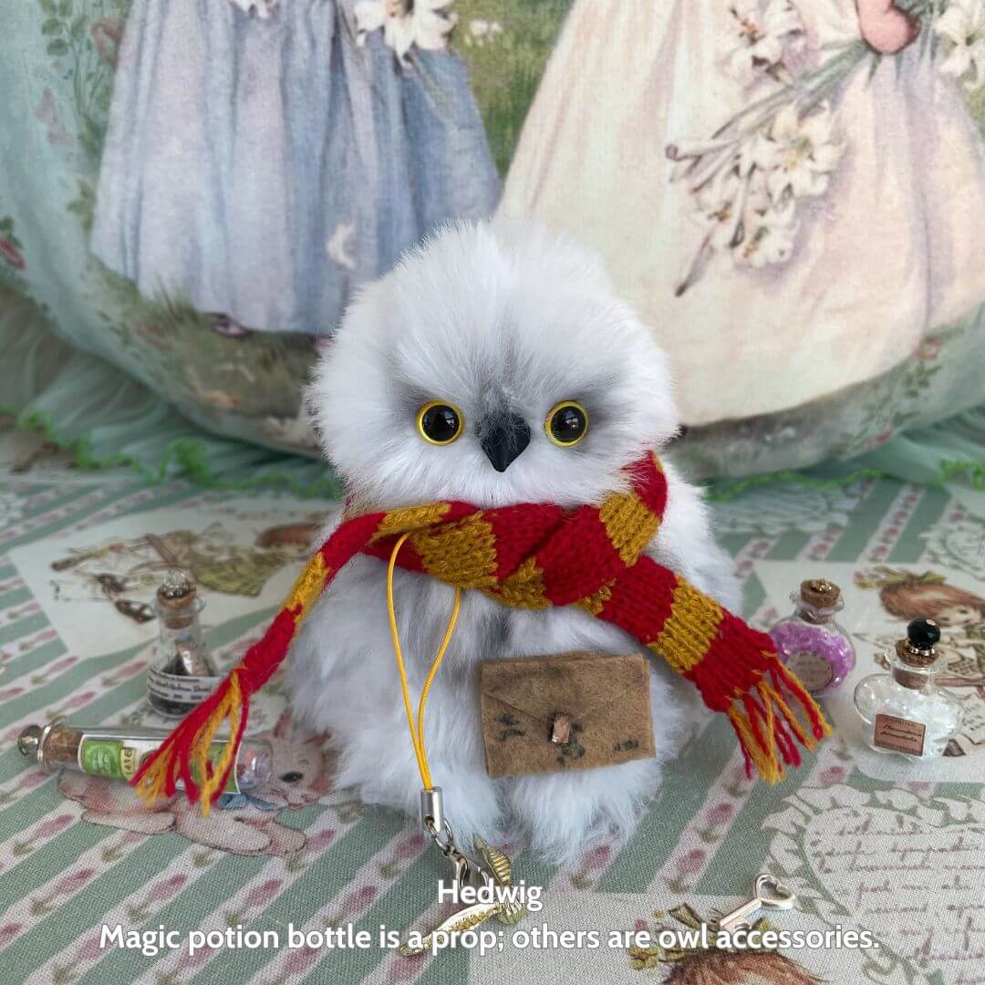 Fluffy Magic Owls - handmade snowy owl with golden eyes, red and gold scarf, and tiny satchel, surrounded by magical accessories.