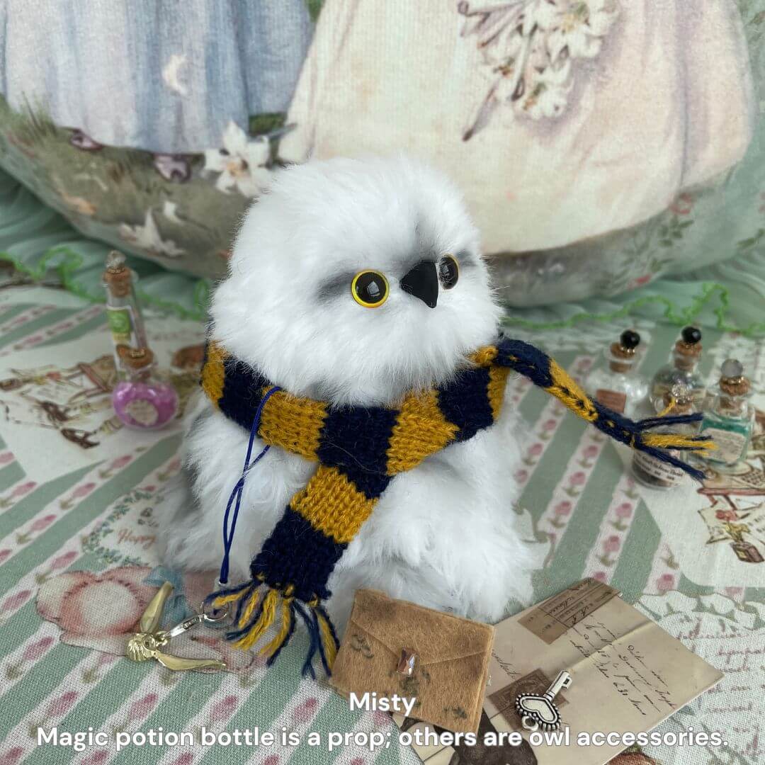 Fluffy Magic Owls miniature snowy owl with golden eyes, wearing a hand-knitted scarf, surrounded by enchanting accessories.