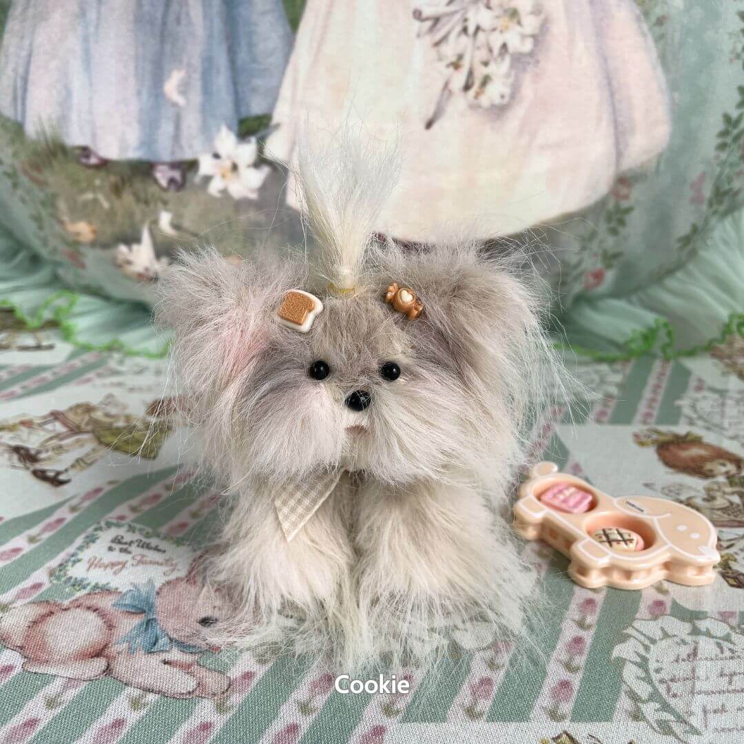 Cute fluffy puppy figurine from the Fluffy Puppy Collection, featuring grey faux fur, tiny bow accessories, and playful expression.