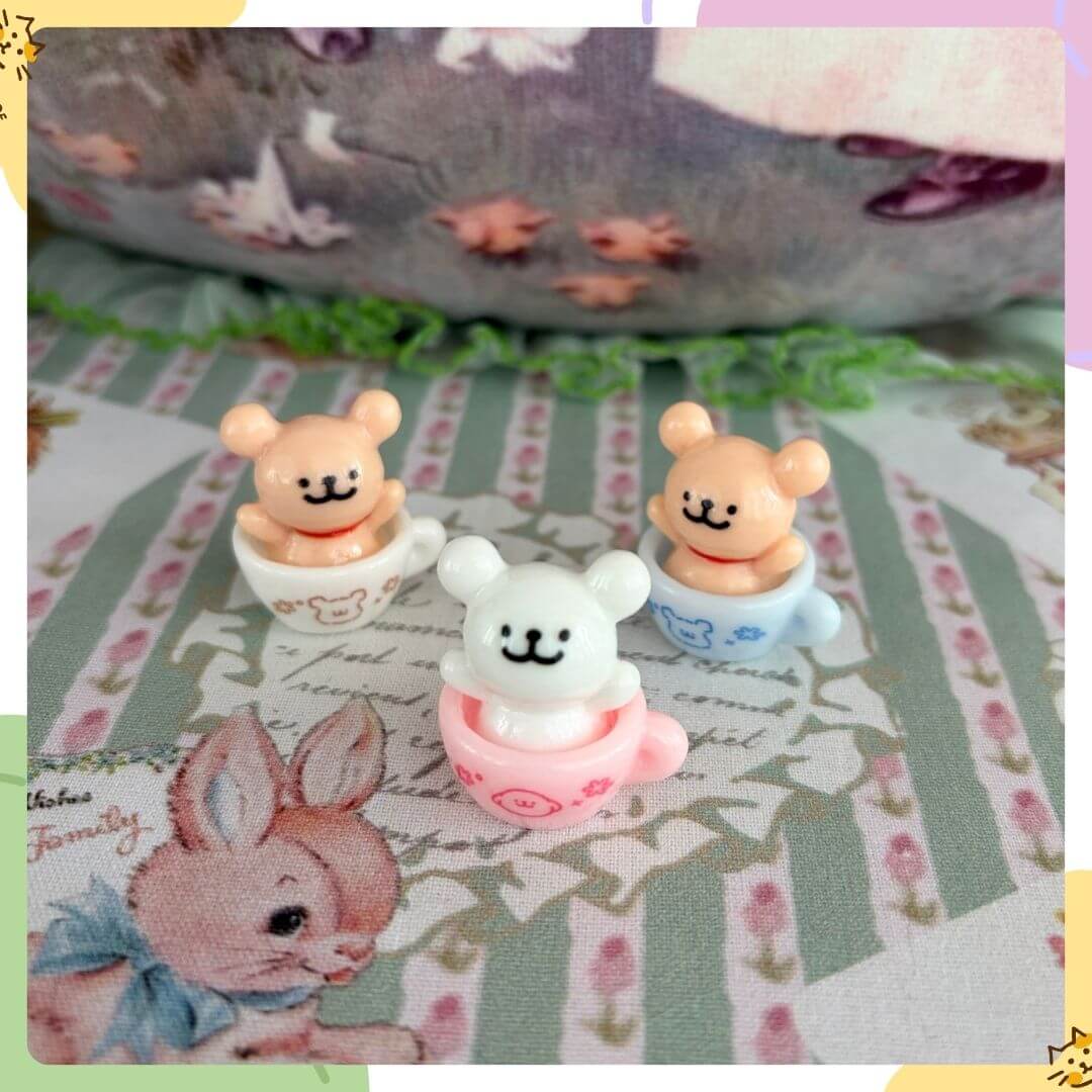 Tiny Puppy Cup with three cute bear figures in pastel colors, peeking out of cups, perfect for whimsical decor.