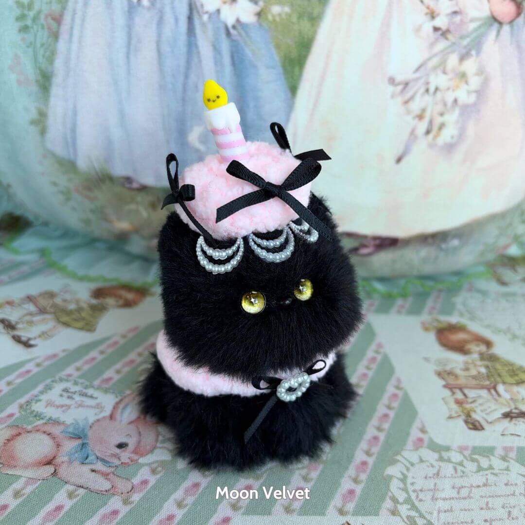 Mewlicious Collection black fluffy kitten figurine with a pink dessert hat and candle, cute collectible handmade in UK.
