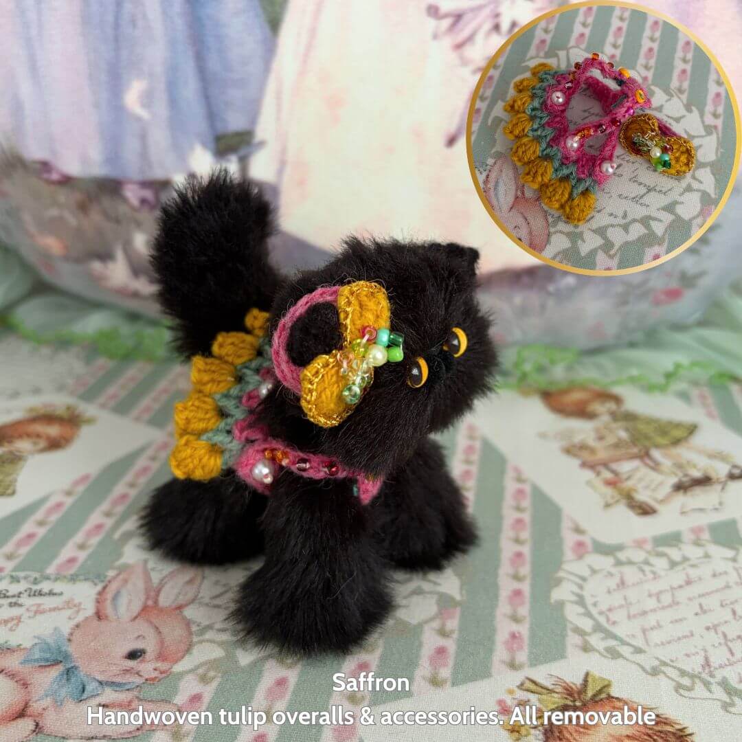 Handmade black fluffy kitten figurine from the Spring Love Limited Collection, dressed in colorful tulip overalls, cute and collectible.