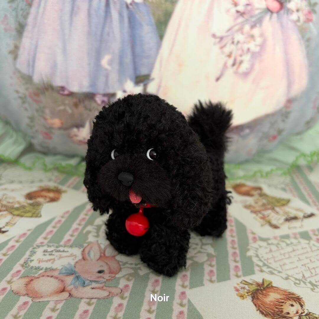 Lifelike Puppy Collection lifelike black puppy figurine with soft fur and red collar, posed playfully on a vintage background.