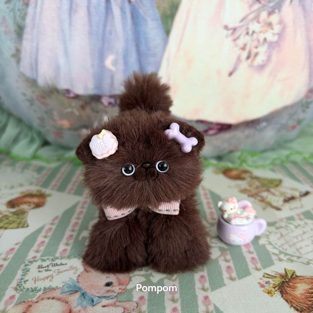 Brown Kitten Collection: fluffy handcrafted brown kitten figurine with flower accessories, cute pose, and playful expression.