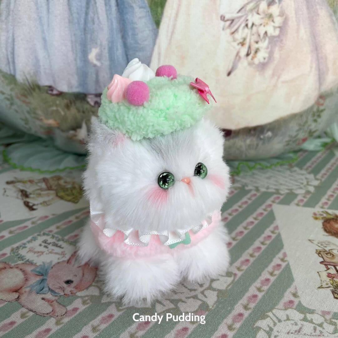 Mewlicious Collection: fluffy kitten figurine in pastel colors wearing a mint-green dessert hat, cute collectible cat with soft details.
