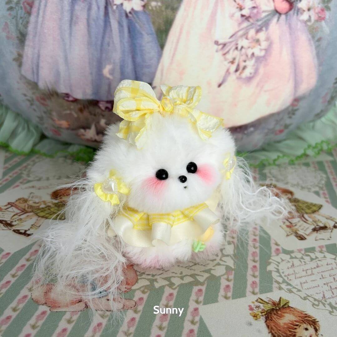 Cute handmade puppy from the Cosplay Puppy Collection, fluffy white with a yellow bow and dress, perfect for collectors.