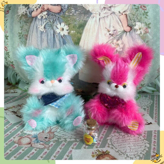 Two Retro Bunny Companions in pastel blue and pink, fluffy, playful, with sparkly accents and a bottle for decoration.