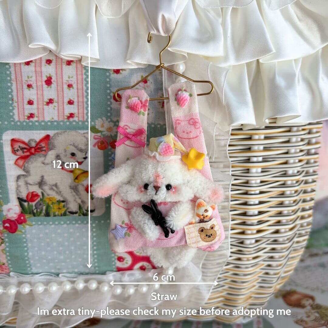Little Hanger Pals handmade fluffy kitten figurine in pastel pink with accessories, hanging from a golden mini hanger.