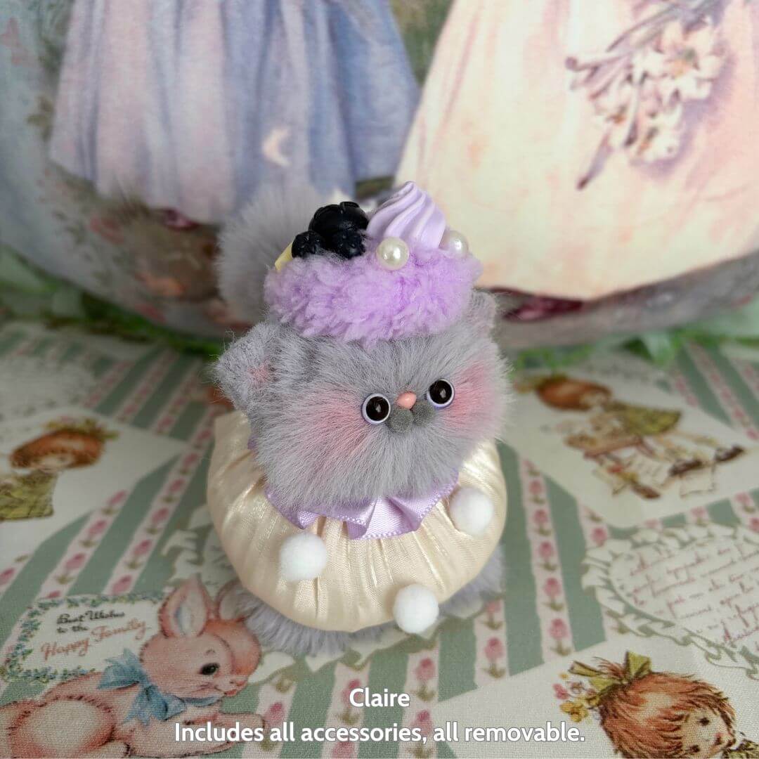 Sweet Treat Kitties cute gray handmade kitten wearing a purple dessert hat, fluffy cat figurine with removable accessories.