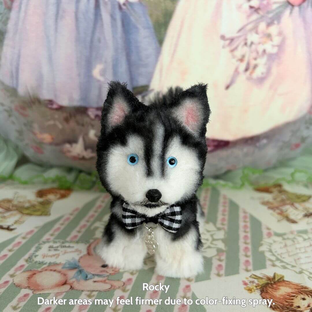 Lifelike Puppy Collection featuring a handmade black and white husky figurine with blue eyes and a bowtie, set on a decorative table.