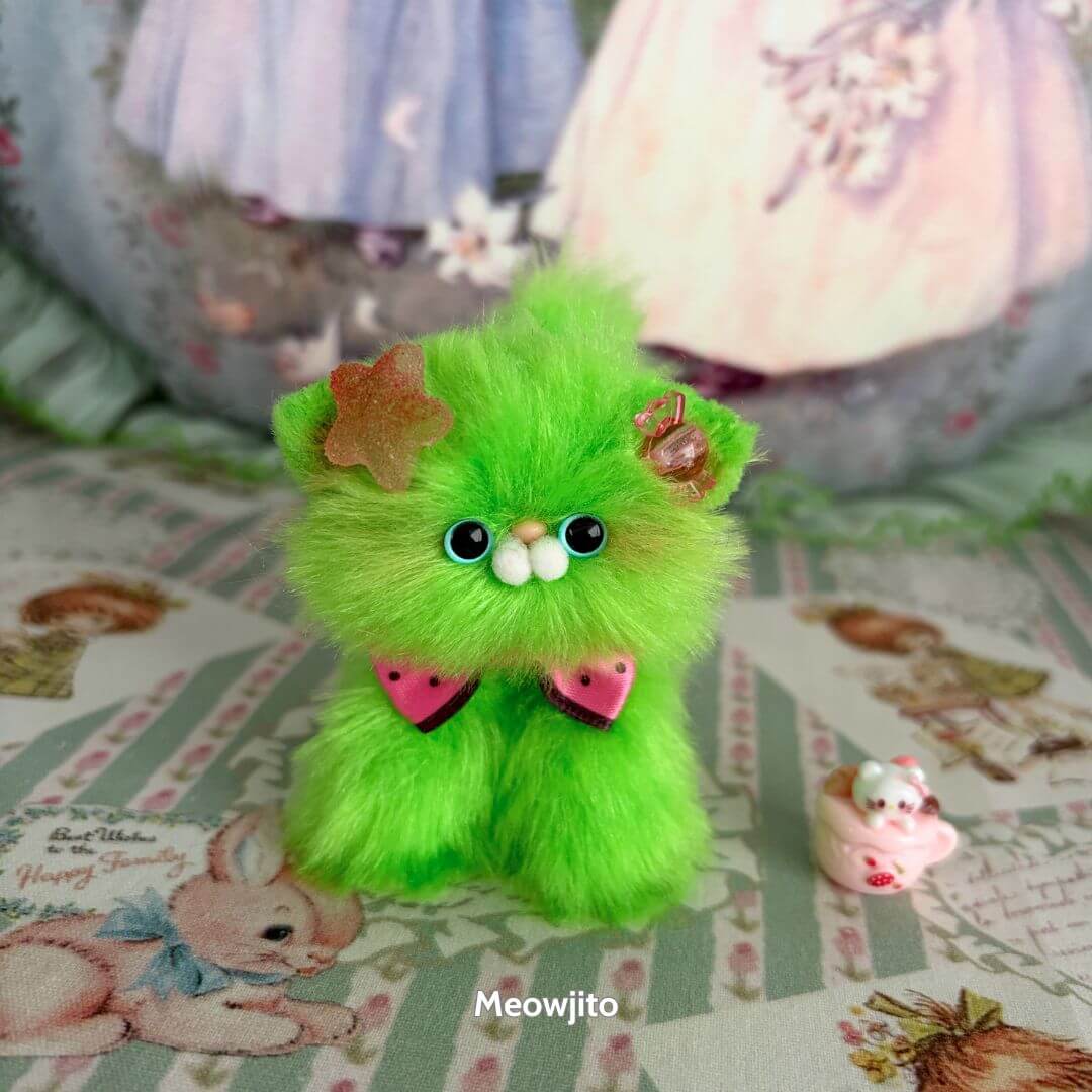 Glossy Meowgic Collection: Fluffy green handmade kitten figurine with star and floral accessories, cute kawaii style.