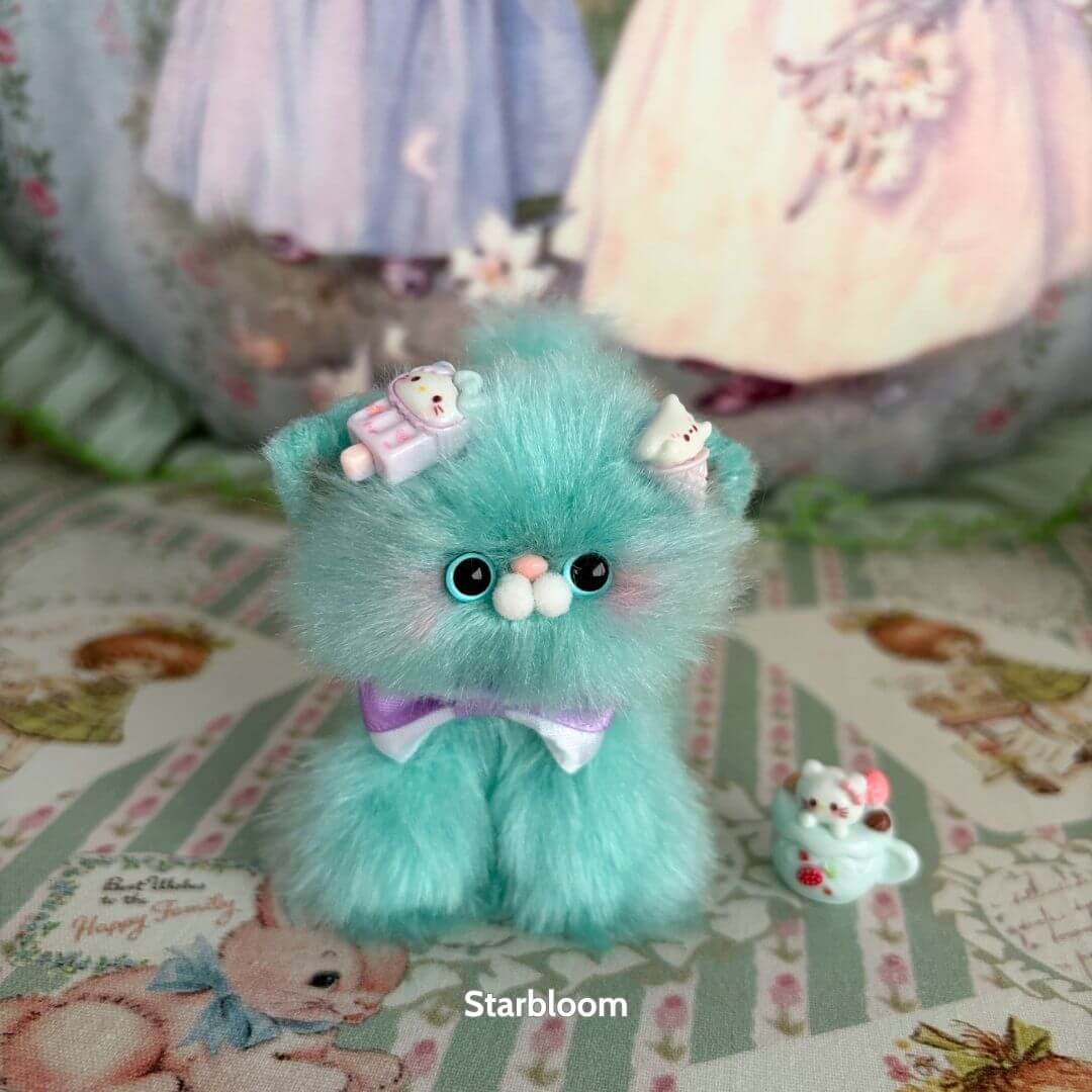 Alt Tag: Glossy Meowgic Collection fluffy kitten in mint green, wearing accessories, with miniature cat figurine, handmade in UK.