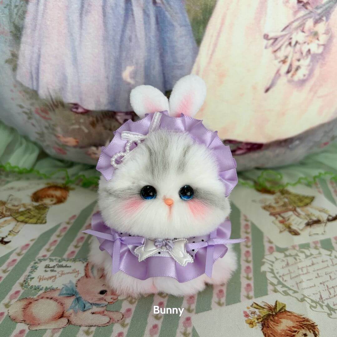 Cute fluffy kitten wearing a lavender dress and bunny ears, part of the Cosplay Kitten Collection, handmade in the UK.