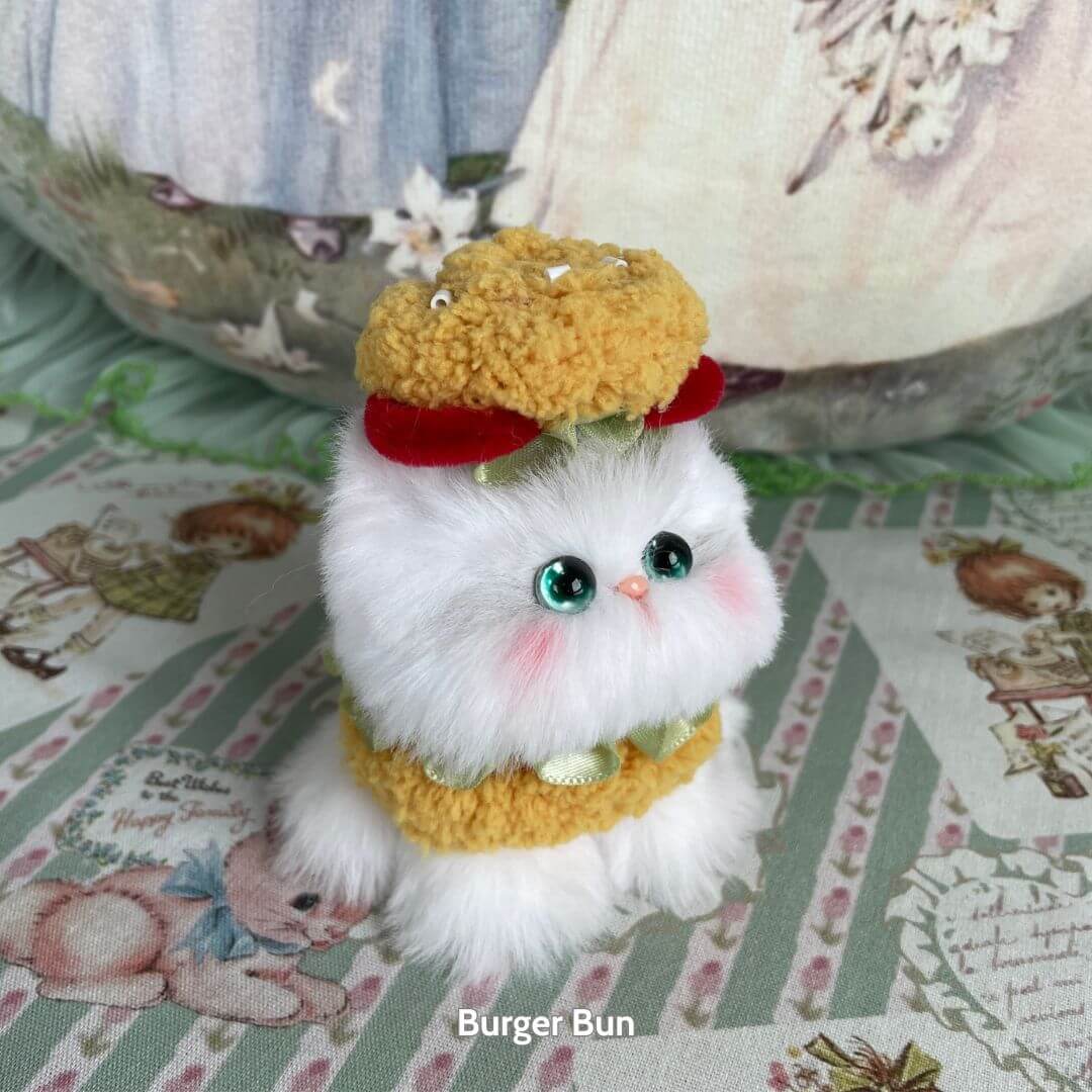 Mewlicious Collection: Cute handmade kitten dressed as a burger bun, fluffy white body, colorful accessories, kawaii style, collectible cat.