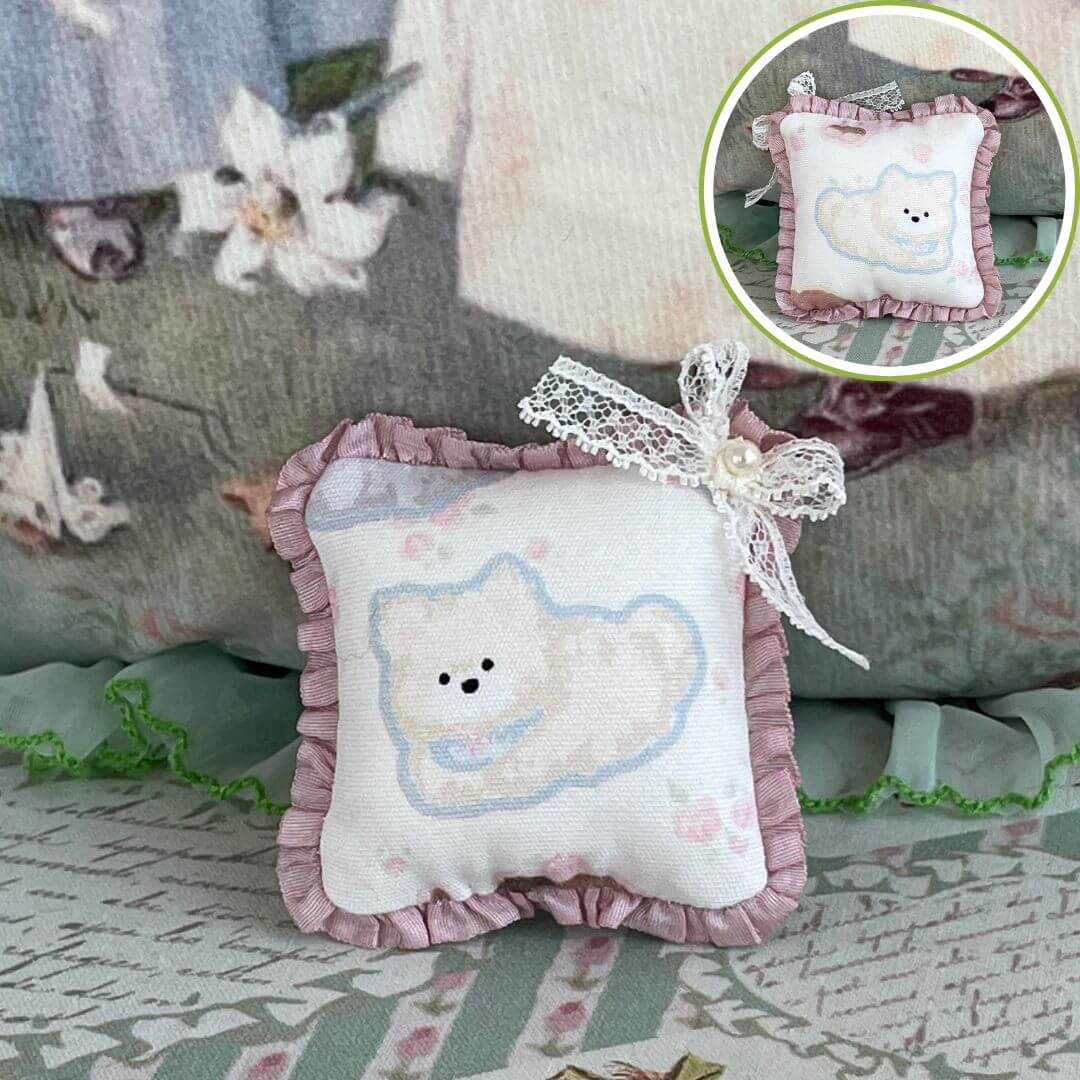 Handmade tiny cuddle critter cushion with kitten design, adorned with a delicate bow, perfect for dolls or desk decor, 6cm x 6cm.