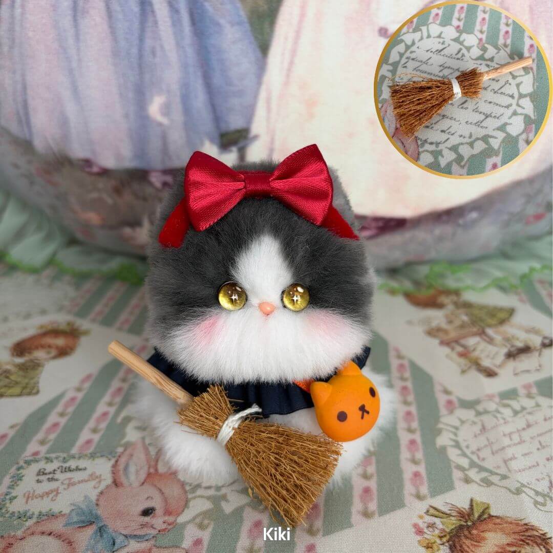 Cosplay Kitten Collection: Fluffy black and white miniature kitten with a red bow and broom, styled as a magic witch.