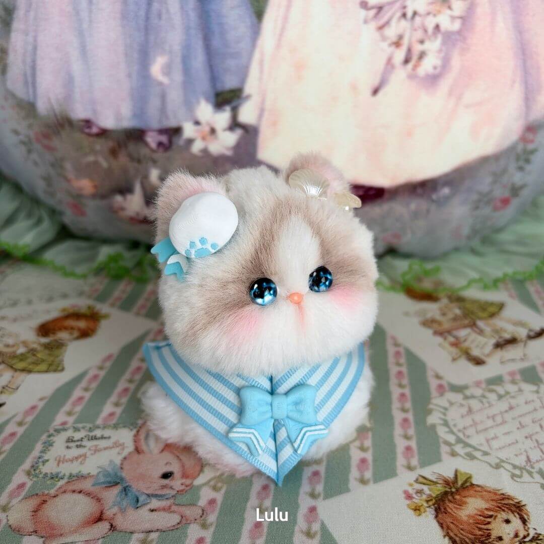 Cute kitten figurine from the Cosplay Kitten Collection, fluffy with blue accessories and sparkling eyes, handmade in UK.