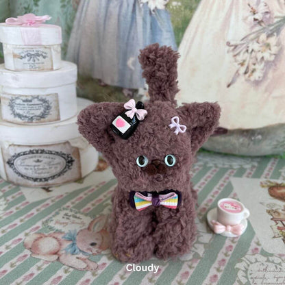 Handmade Devon Rex plush toy in brown faux fur with accessories, set in a vintage-style decor. Ideal for collectibles or decor.