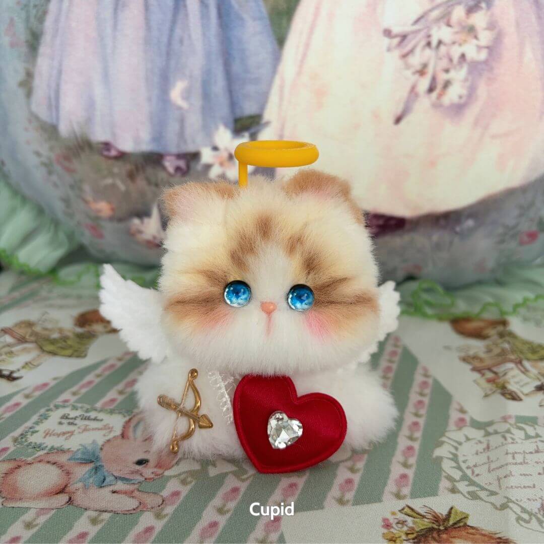 Handmade kitten from Fairy Paws Collection with fluffy fur, blue eyes, angel wings, and heart accessory, cute animal collectible.