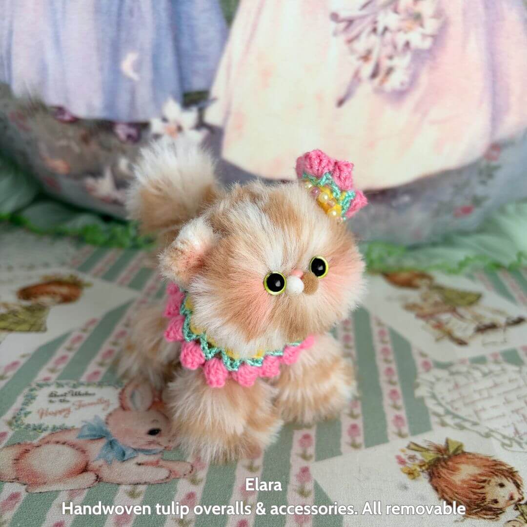 Spring Love Limited Collection handmade kitten figurine in pastel colors, wearing a floral accessory and posing adorably.