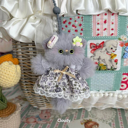 Adorable handmade kitten in a floral dress with fluffy grey fur, part of the exclusive Pawsh Pendants collection.