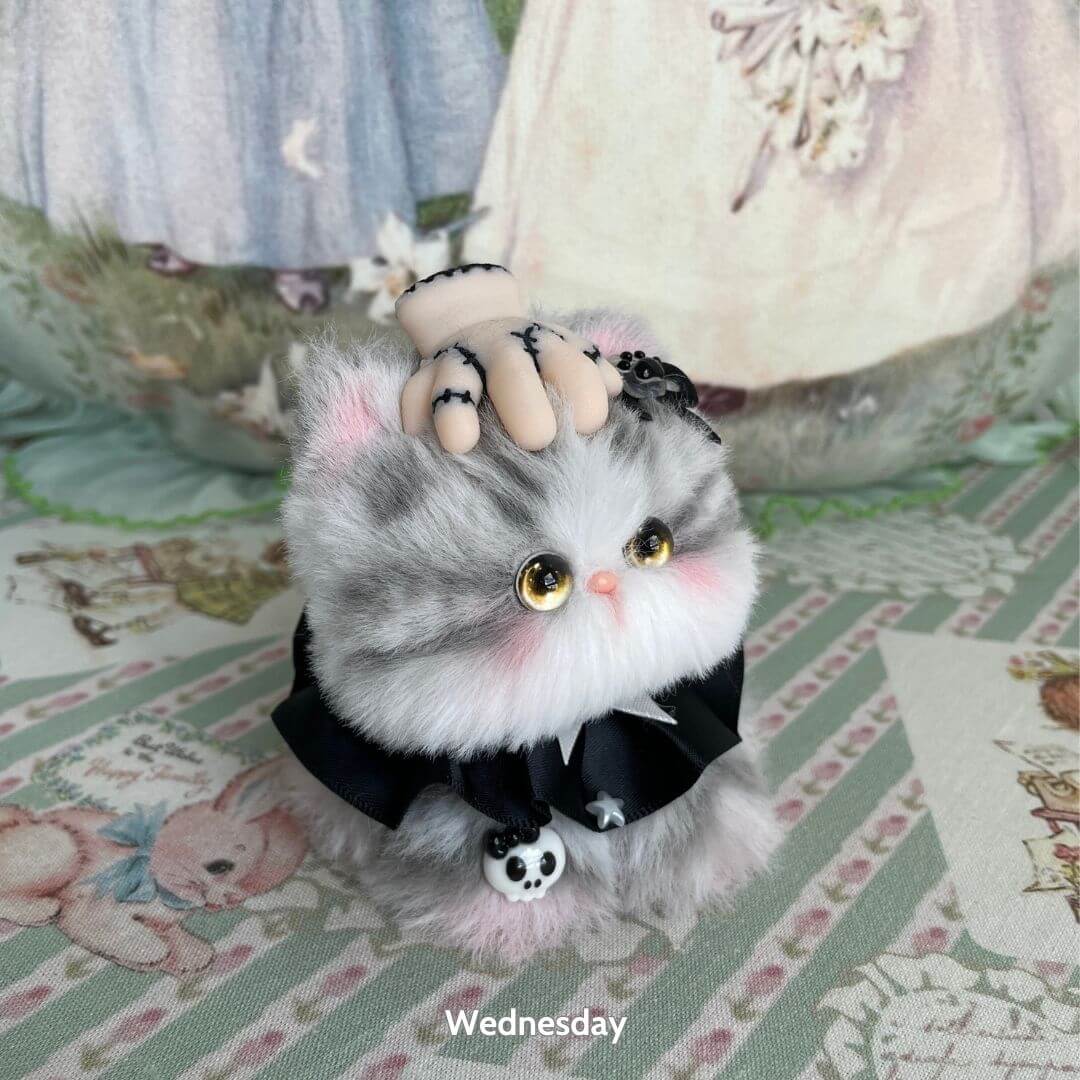 Cosplay Kitten Collection: fluffy grey kitten in a black dress with a decorative hand accessory, kawaii style, collectible figurine.