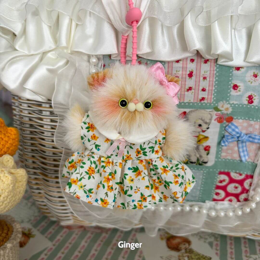 Pawsh Pendants: adorable fluffy kitten figurine in floral dress with pink bow, handmade in UK, cute collectible decor.