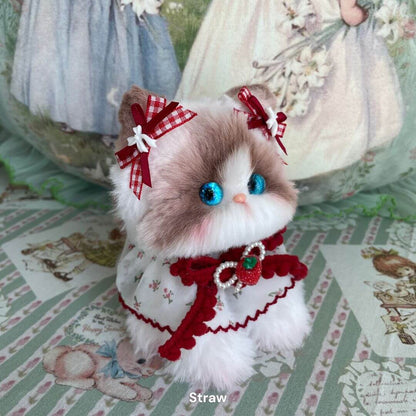 Cute fluffy kitten figurine from the Enchanted Big Paws Collection, wearing a red cape with bows, vibrant blue eyes, and unique design.