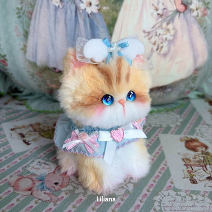 Cute fluffy kitten from the Enchanted Big Paws Collection, styled in pastel colors with a bow and blue eyes, perfect collectible decor.