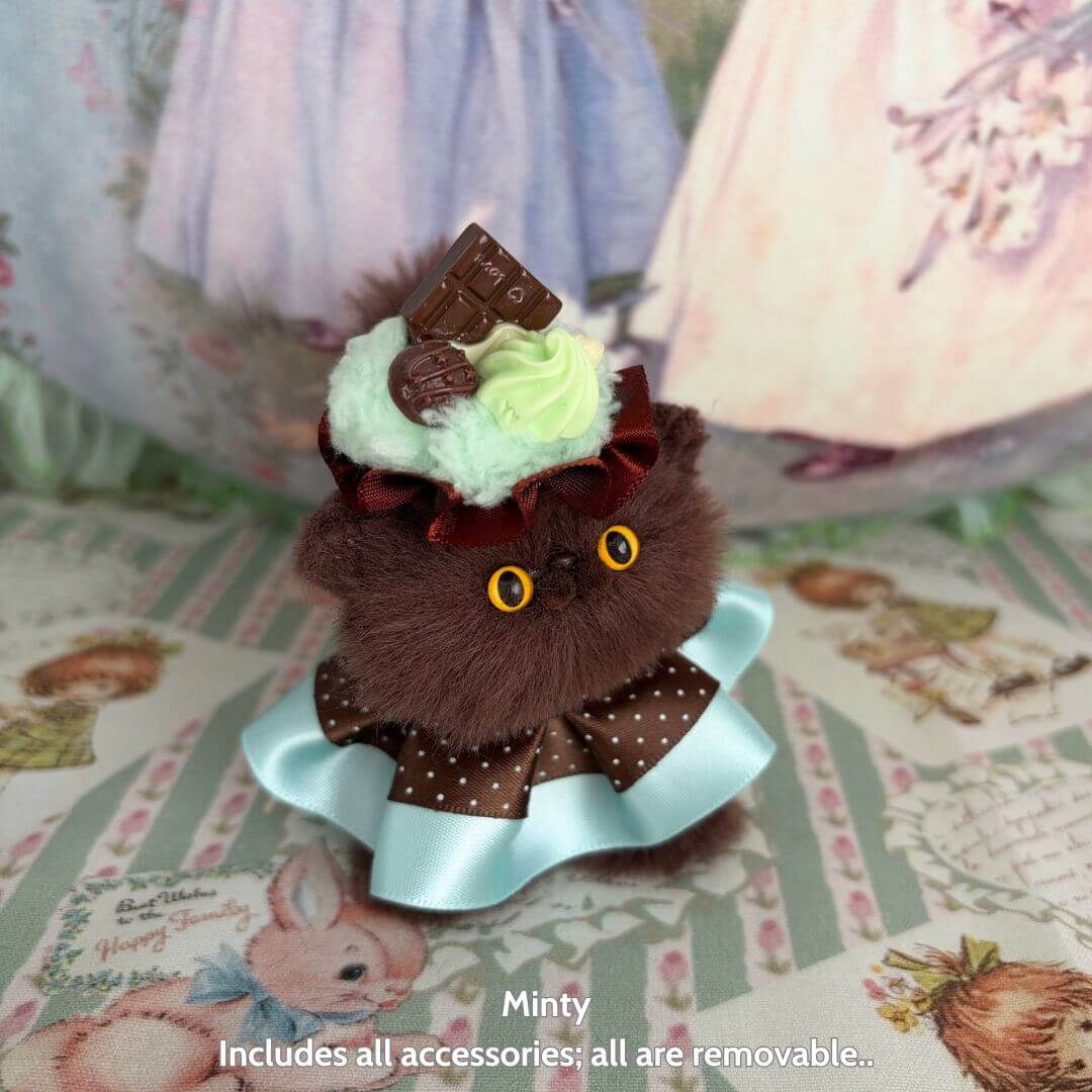 Sweet Treat Kitties plush kitten named Minty, featuring brown fluffy fur, dessert-themed accessories, and a cute kawaii style.