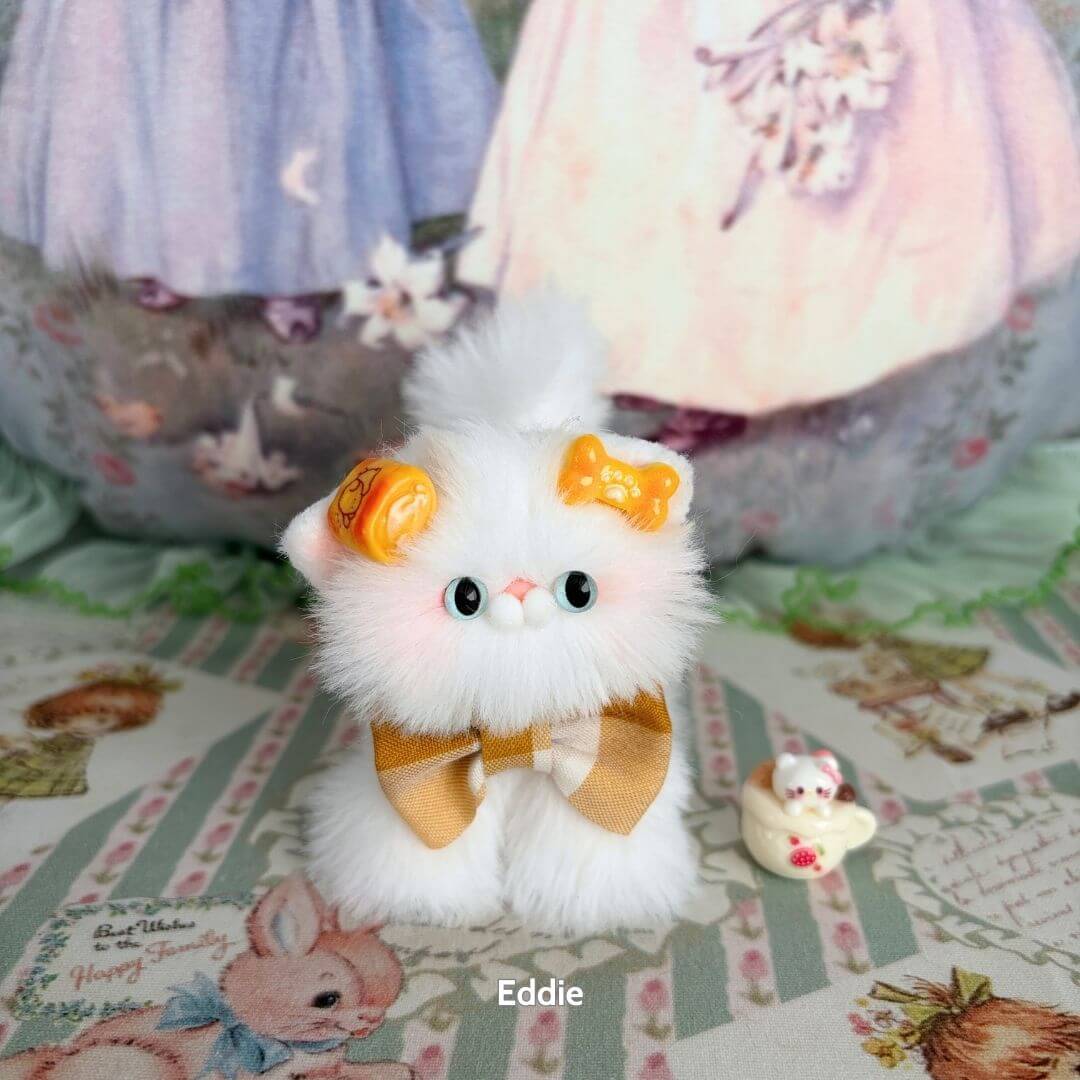 Adorable white kitten from the White Kitten Collection, featuring pastel accessories and a fluffy coat, perfect as a collectible cat figurine.