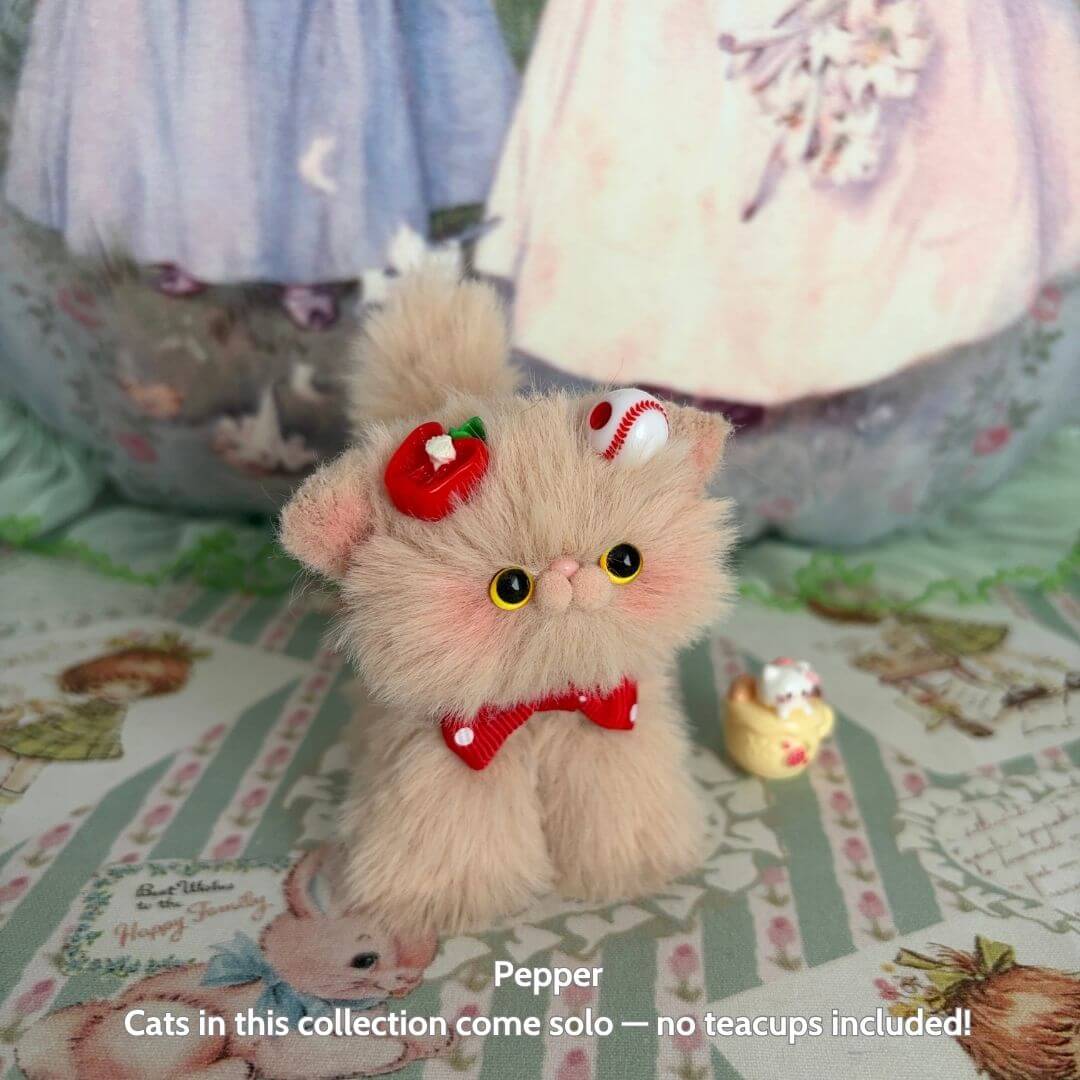 Brown Kitten Collection featuring a fluffy handmade kitten with a red bow and dessert-themed accessories, posed cutely.
