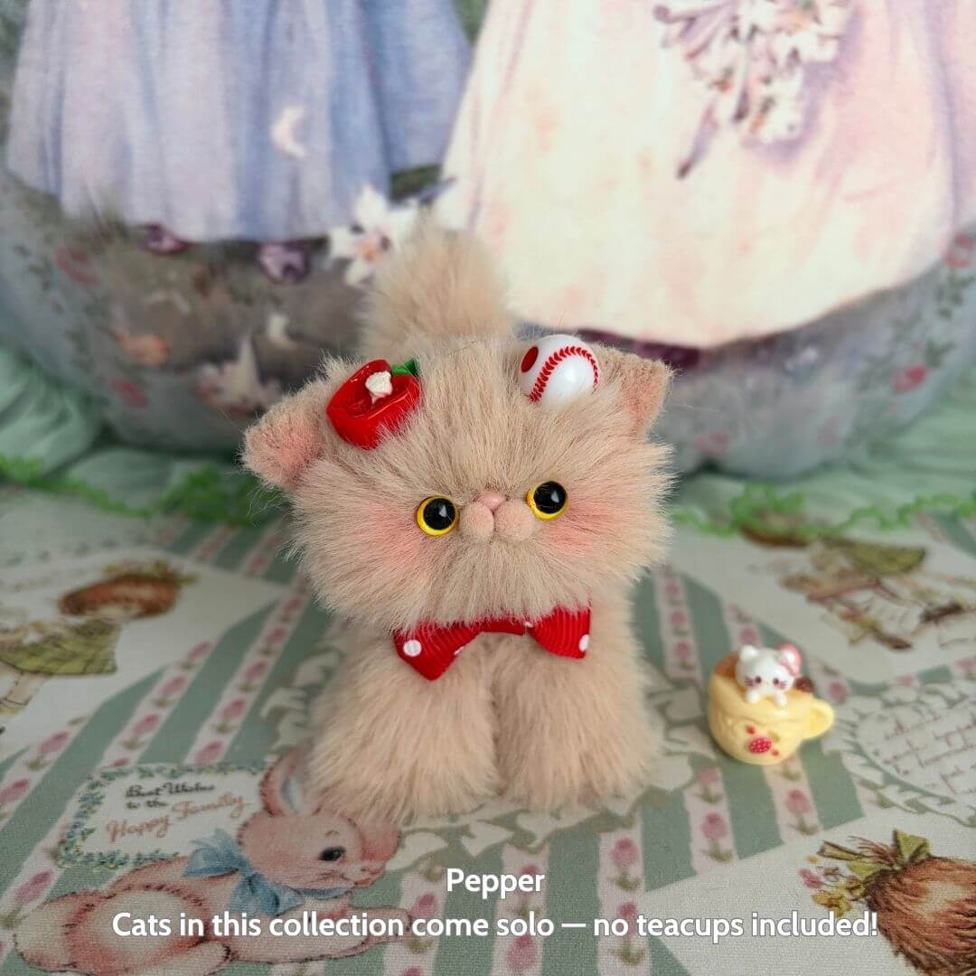 Alt Tag: Brown Kitten Collection features Pepper, a kawaii fluffy cat figurine with a red bow and dessert accessory, handmade in UK.