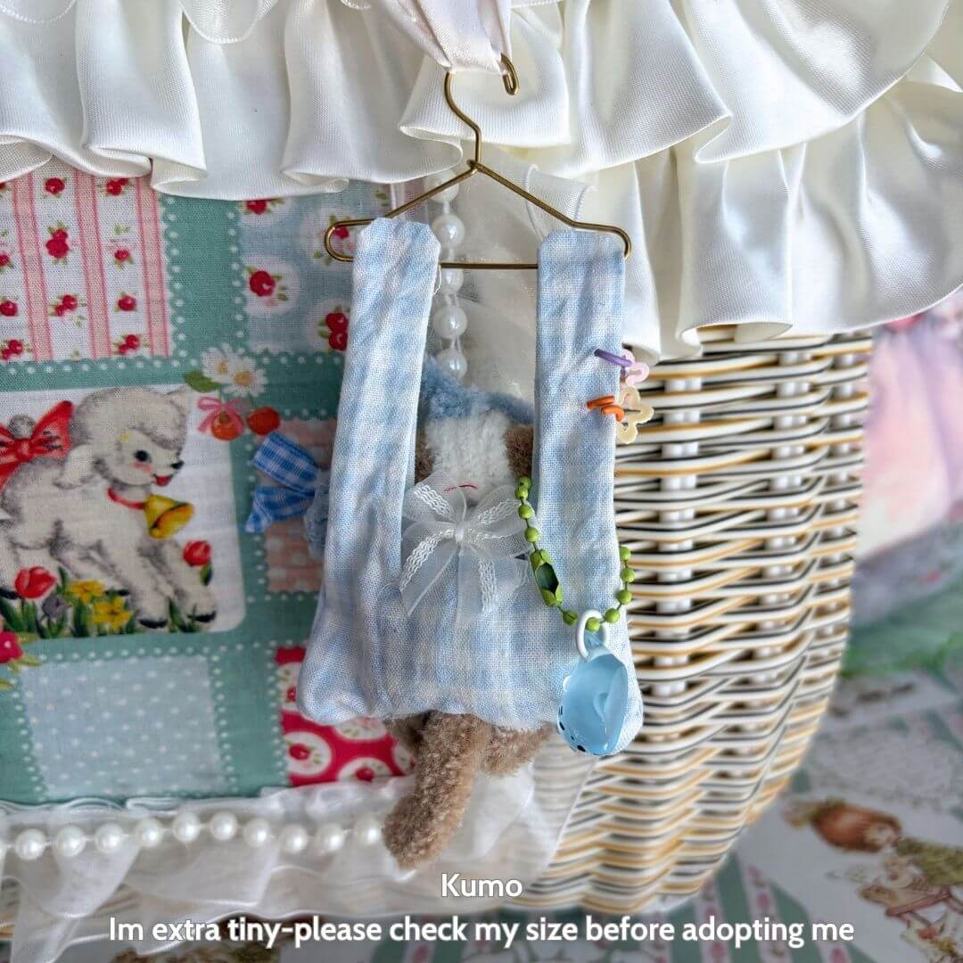 Little Hanger Pals handmade kitten hanging from a miniature hanger in blue checkered fabric with cute accessories.