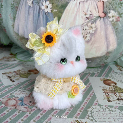 Handmade kitten from the Enchanted Big Paws Collection, fluffy white cat figurine with sunflower accessories in a cute pose.